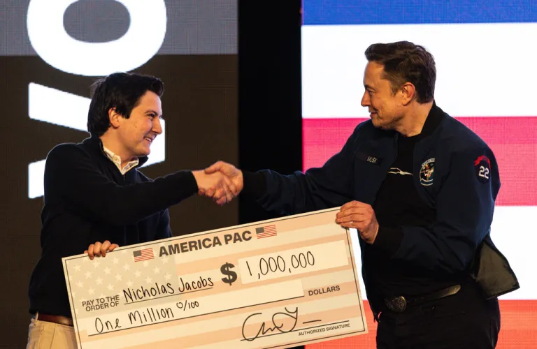 Elon Musk hands over a million dollar check.