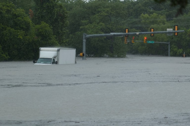 A truck sits submerged in flood waters.