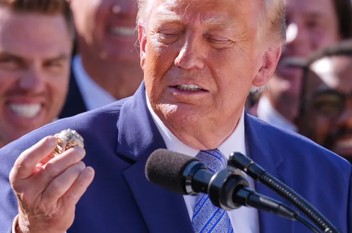 Trump holds a World Series ring gifted to him by the Dodgers.