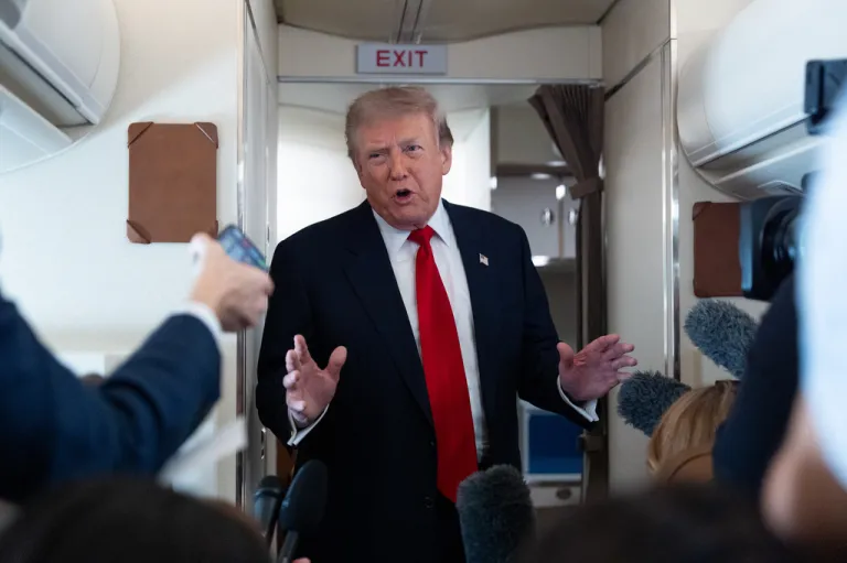 President Donald Trump speaks with reporters while on Air Force One en route to Oakland County International Airport, Monday, July 27, 2026, in Waterford Township, Mich.