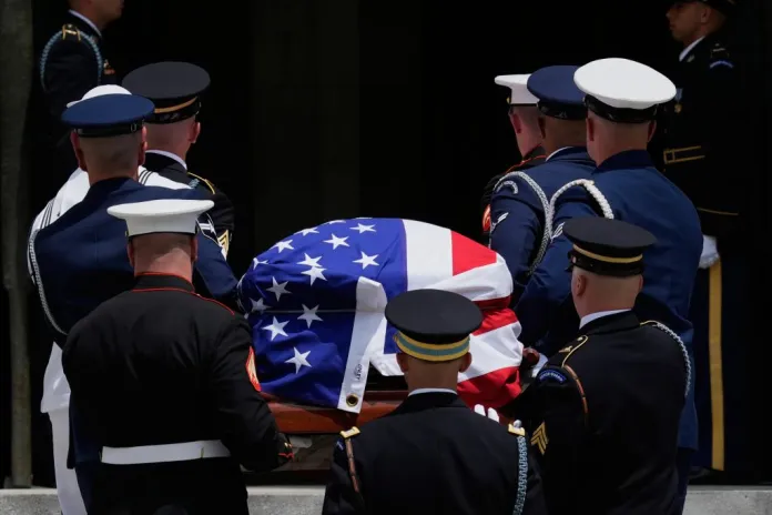 An Armed Forces Body Bearer Team carries the flag-draped casket of Sen. Lindsey Graham into the Washington National Cathedral