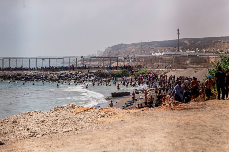 Migrants cross from Morocco into the Spanish enclave of Ceuta.