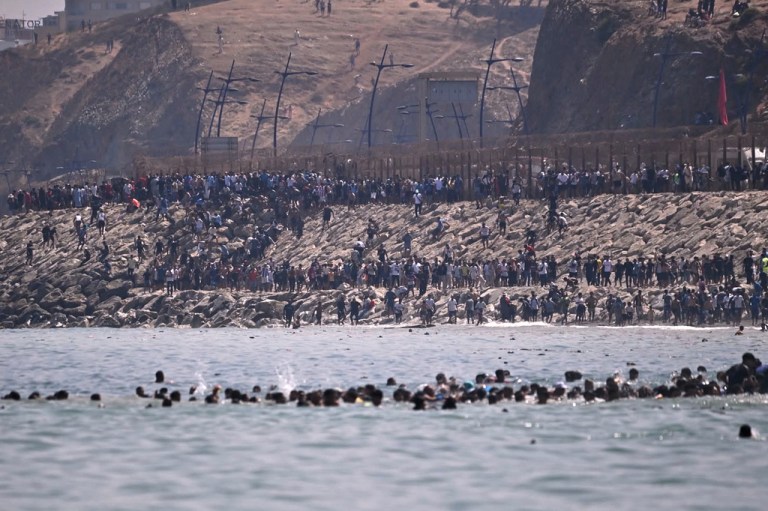 Migrants cross from Morocco into the Spanish enclave of Ceuta, Thursday, July 30, 2026.