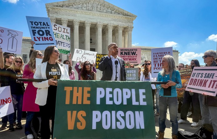 Sen. Cory Booker (D-NJ) addresses a rally in front of the U.S. Supreme Court in the case of Monsanto Company v. Durnell on April 27. Lawyers for Bayer, which now owns Monsanto, seek to deny legal relief to cancer patients who say they became ill because of exposure to glyphosate in Roundup. (Sue Dorfman/ZUMA Press Wire via Newscom)