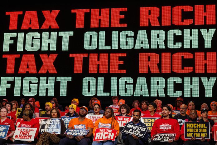 People attend a Tax The Rich rally hosted by the Democratic Socialists of America at Lehman College in the borough of the Bronx in New York, NY, United States on March 29, 2026. (Photo by Jason Alpert-Wisnia / Hans Lucas / AFP via Getty Images)