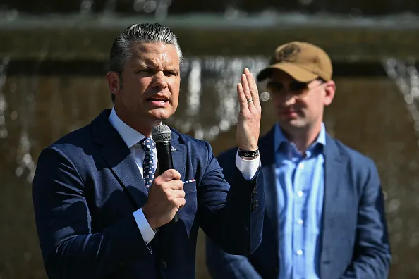 US Secretary of Defense Pete Hegseth (L) speaks alongside White House Deputy Chief of Staff Stephen Miller (R) during a