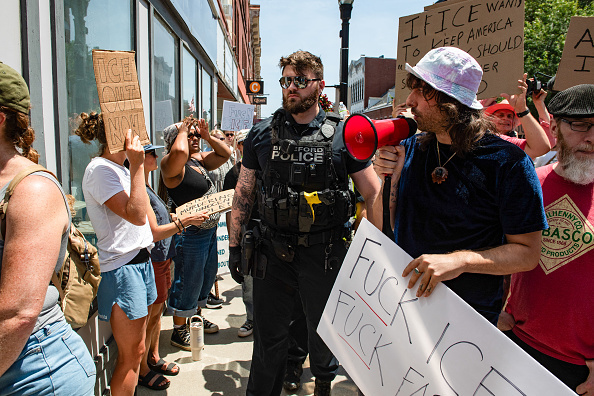 Demonstrators gather outside the office of Sen. Susan Collins (R-ME).