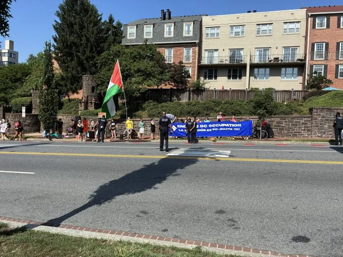 Protesters chant outside of Meridian Hill Park in Washington, D.C. during Secretary of War Pete Hegseth's address to members of the National Guard's DC Task Force.