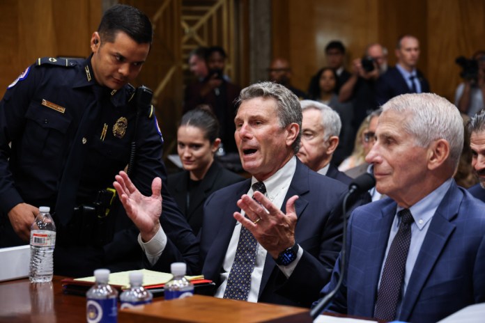 Capitol Police escort out Anthony Fauci's lawyer during Senate hearing. (Graeme Jennings/Washington Examiner)