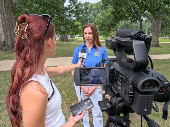 Woman interviews in front of camera