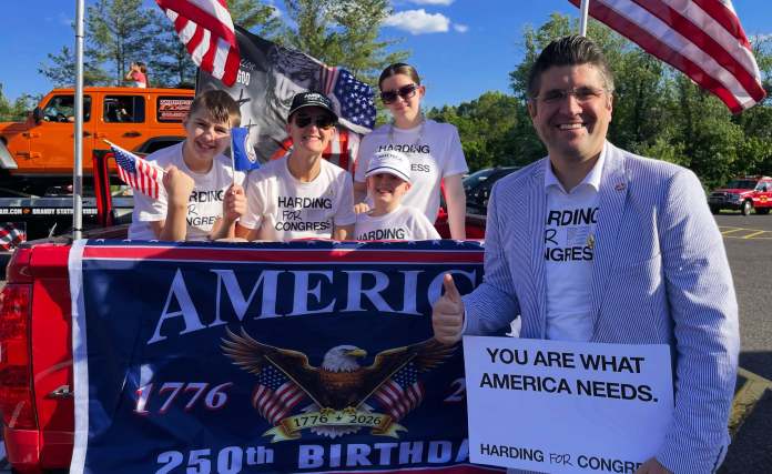 Man holding sign smiling