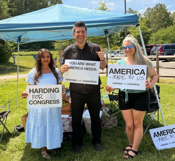 People holding campaign signs smiling