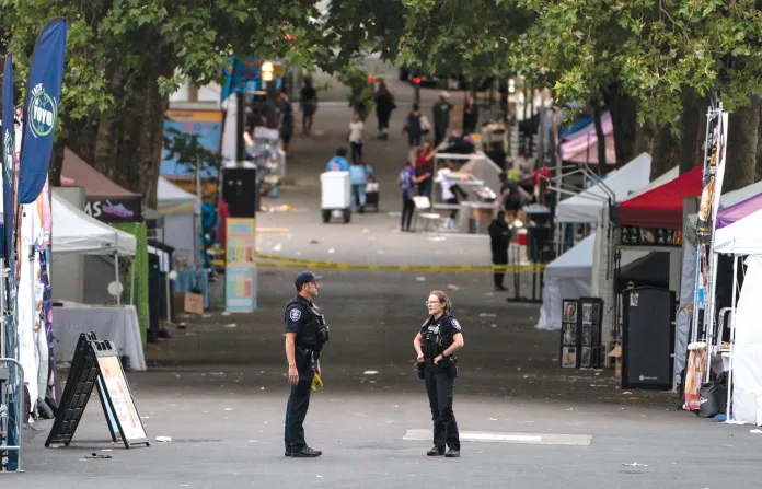 Police officers keep watch after a mass shooting at the Bite of Seattle food festival on July 26 in Seattle. (Getty Images)