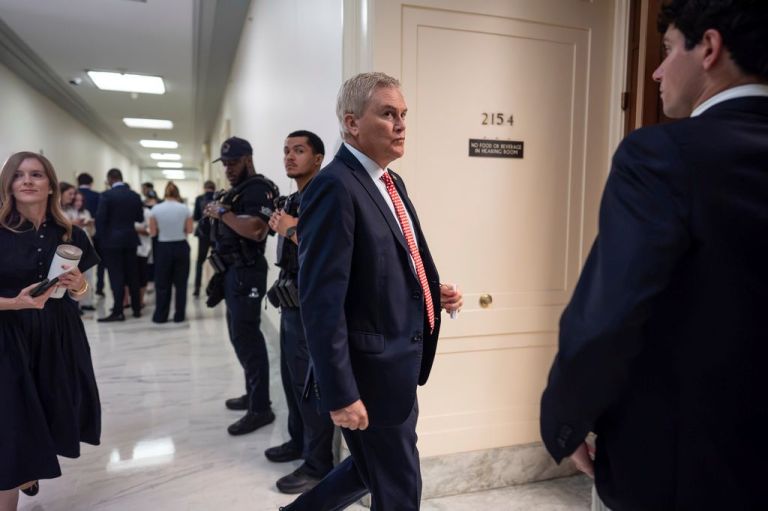 Rep. James Comer (R-KY) walks in a hallway on the Hill.