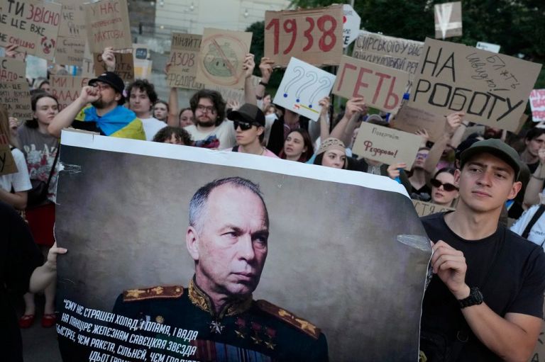 Activists hold a portrait of Ukraine's Armed Forces Commander-in-Chief Oleksandr Syrskyi demanding his resignation during a rally to denounce President Volodymyr Zelenskyy's decision to dismiss Defense Minister Mykhailo Fedorov after six months in the post, in Kyiv, Ukraine, Saturday, July 18, 2026.