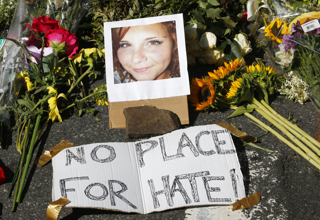 A photo of Heather Heyer rests among a makeshift memorial in Charlottesville, Va., on Aug. 13, 2017. Heyer was struck and killed by a car while protesting a white nationalist rally on Aug. 12. (AP Photo/Steve Helber)