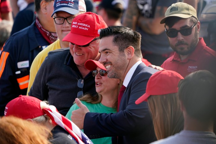 Pennsylvania Republican congressional candidate Sean Parnell poses for photos ahead of a campaign rally with President Donald Trump Tuesday, Sept. 22, 2020 in Moon Township, Pa. (AP Photo/Keith Srakocic)