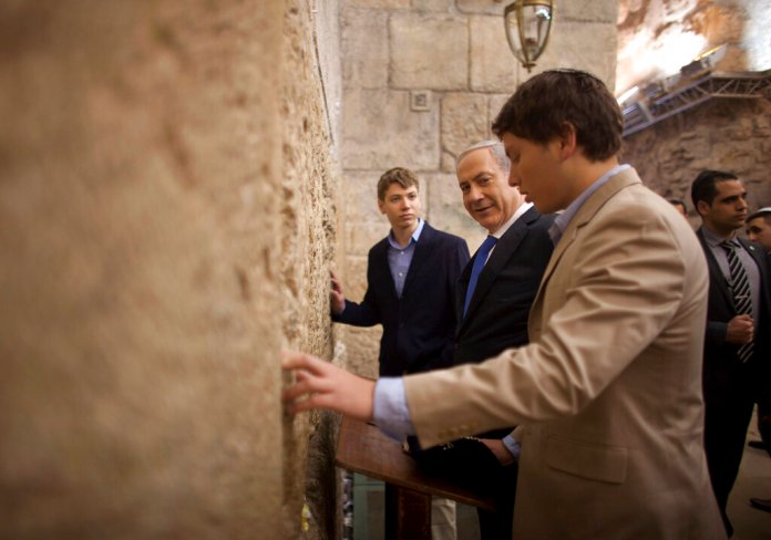 Israeli Prime Minister Benjamin Netanyahu prays with his sons, Avner Netanyahu and Yair Netanyahu.