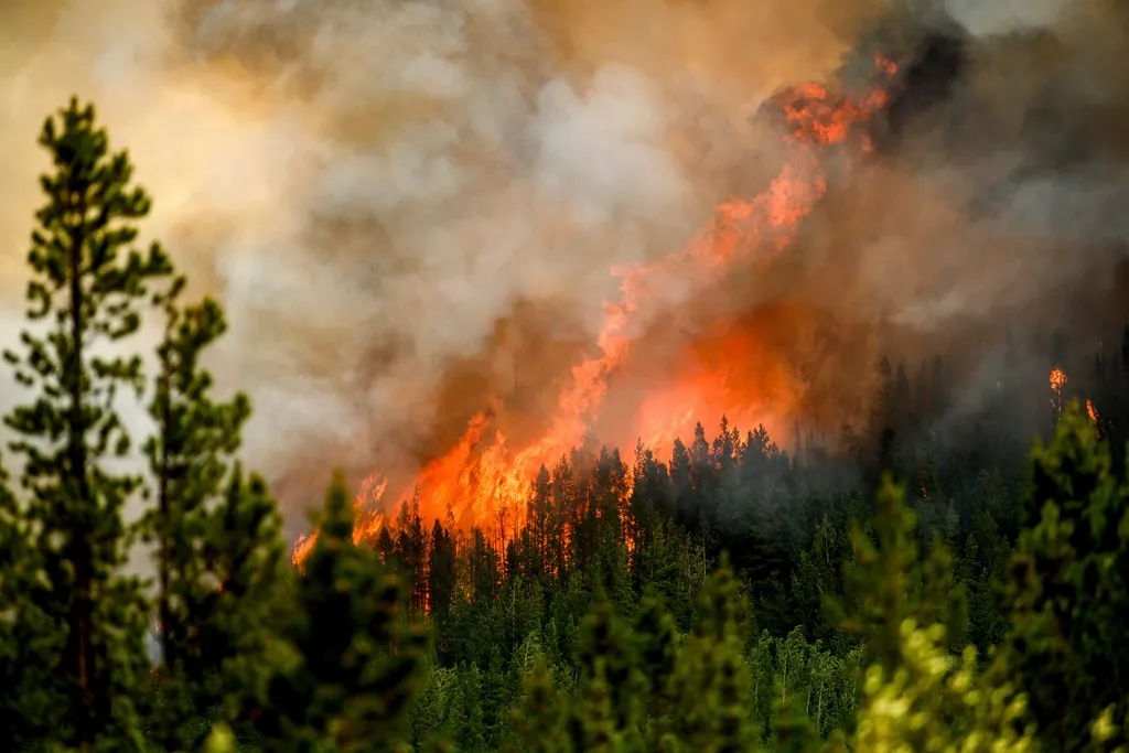 A fast-moving wildfire forces more than 20,000 people to evacuate in western Canada