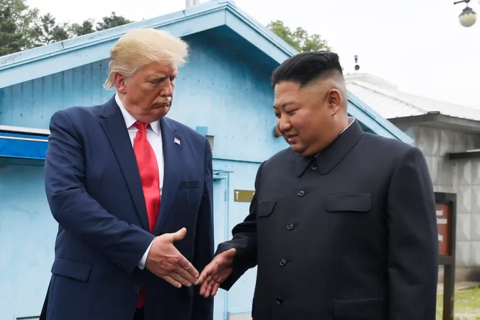 Trump shakes hands with Kim Jong Un