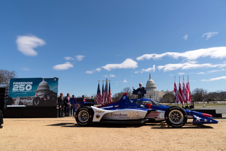 President of Penske Corporation Bud Denker speaks during the announcement of the street race circuit "Freedom 250 Grand Prix Washington, D.C." next to a IndyCar show car.