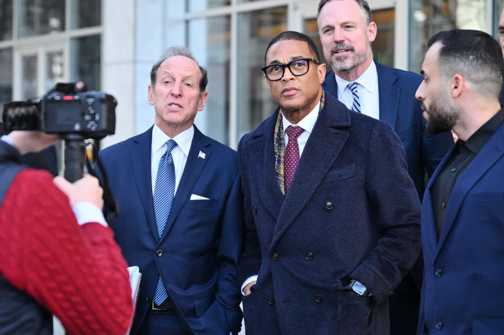 Journalist Don Lemon, center, exits the U.S. District Courthouse in St. Paul.