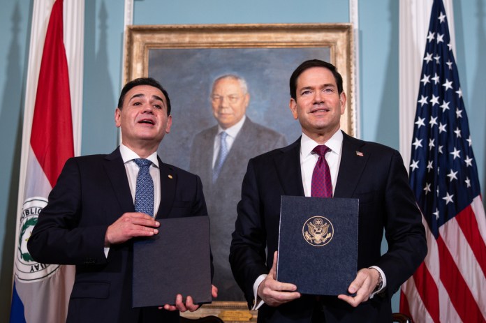 Secretary of State Marco Rubio, holds a signed treaty alongside Paraguay's Vice President Pedro Alliana in the Treaty Room at the State Department, Tuesday, Aug. 4, 2026, in Washington.