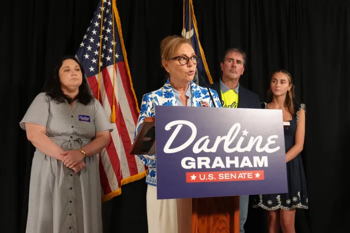 From left, Emilie Boggs Roberts, Larry Nordone and Nicole Nordone listen as Sen. Darline Graham, R-S.C., speaks to reporters after advancing to a special GOP Senate primary runoff to replace Sen. Lindsey Graham, R-S.C., on Tuesday, Aug. 11, 2026, in Columbia, S.C.