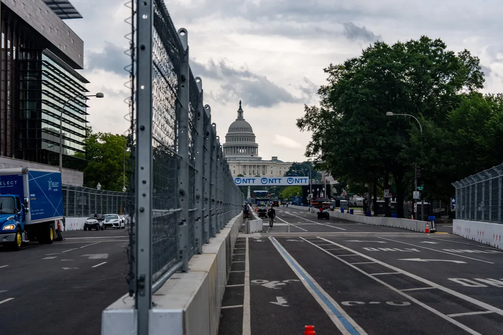 Fencing is in place on Pennsylvania Avenue with the U.S. Capitol in the background ahead of the Freedom 250 Grand Prix, Thursday, Aug. 20, 2026, in Washington. (AP Photo/Alex Brandon)