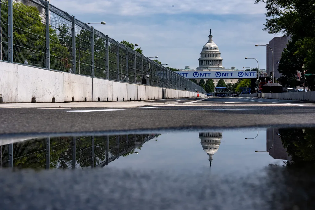 Fencing is in place on Pennsylvania Avenue with the U.S. Capitol in the background ahead of the Freedom 250 Grand Prix, Thursday, Aug. 20, 2026, in Washington. (AP Photo/Alex Brandon)