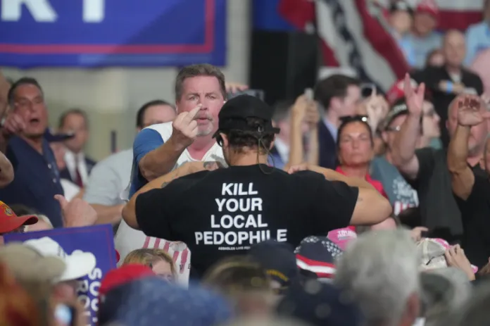 Supporters of President Donald Trump react to a protester who interrupted the president's speech at a campaign rally