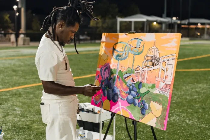 An artist paints at Diner en Blanc in Washington, D.C., (Courtesy of The Davis Group).