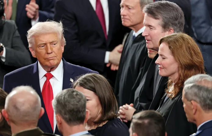 Arriving at the House of Representatives Chamber for a State of the Union address, President Donald Trump passes Amy Coney Barrett (second from right), along with Chief Justice John Roberts (at top) and Associate Justice Brett Kavanaugh (third from right), Feb. 24, 2026. (Win McNamee/Getty)