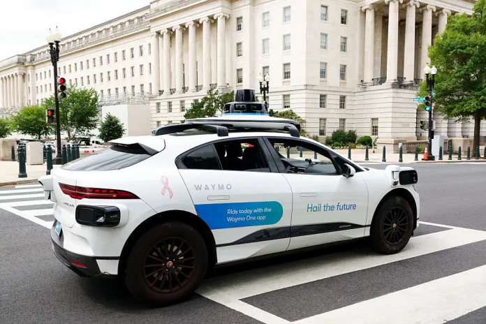 WASHINGTON, DC - JUNE 8: A Waymo autonomous Jaguar I-PACE vehicle is driven on a road on June 8, 2026 in Washington, DC. Waymo is still in the testing phase and is not yet operating commercially in the region.