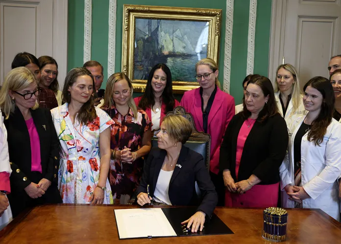 Massachusetts Governor Maura Healey turns to the women gathered behind her after signing a bill prioritizing patient access to care to strengthen abortion protections in Massachusetts at the State House on August 10, 2026. (Photo by Jessica Rinaldi/The Boston Globe via Getty Images)