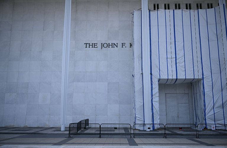 Scaffolding and a large protective tarp is covering part of the facade of the John F. Kennedy Center for the Performing Arts in Washington, DC, on August 13, 2026. US President Donald Trump has sought to burnish his legacy by getting his name and image placed on everything, from limited edition passports to a Florida airport. His efforts to put his stamp on the Kennedy Center arts complex in Washington -- blocked earlier this year by a federal judge -- moved ahead once again on August 13. (Photo by Brendan SMIALOWSKI / AFP via Getty Images)
