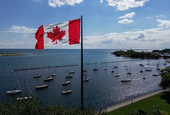 A Canadian flag flies along the waterfront of Lake Ontario, in Toronto, Ontario, Canada, on August 27, 2026. US President Donald Trump announced that he is renaming Lake Ontario -- a large body of water shared by the United States and Canada -- "Lake America." Trump signed an order in the White House in a move that comes amid a spiraling trade war between the world's largest economy and its northern neighbor.