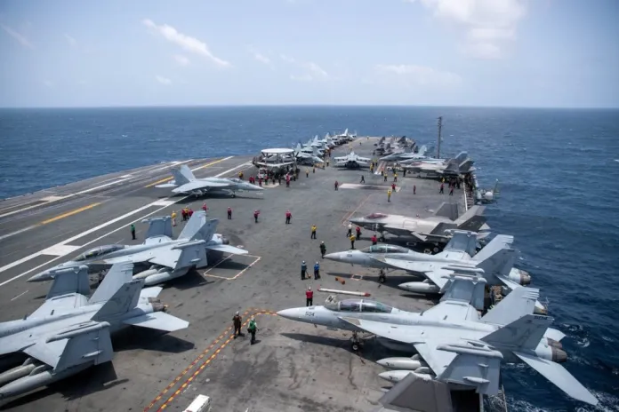 U.S. Sailors work on the flight deck of USS George Washington (CVN 73), Aug. 20, as the aircraft carrier transits the Arabian Sea.