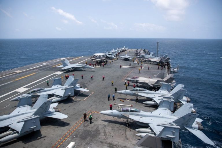 U.S. Sailors work on the flight deck of USS George Washington (CVN 73), Aug. 20, as the aircraft carrier transits the Arabian Sea.