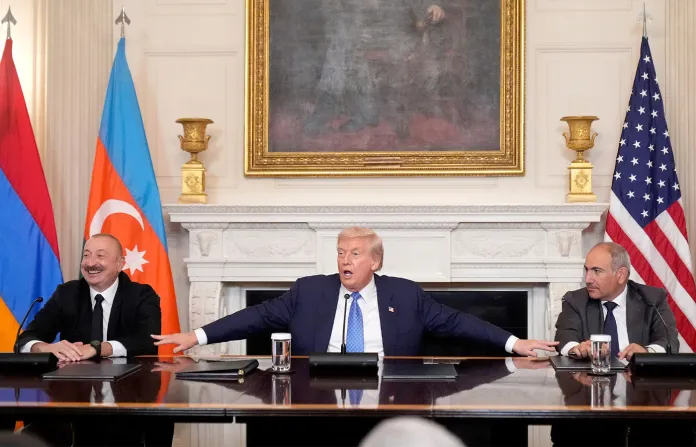 President Donald Trump, joined by Armenian Prime Minister Nikol Pashinyan (right) and Azerbaijan President Ilham Aliyev (left), speaks during a trilateral signing ceremony at the White House on Aug. 8, 2025. (Mark Schiefelbein/AP)