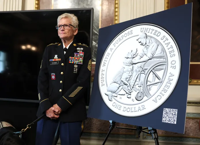 US Army Command Sergeant Major Gretchen Evans listens as U.S. Mint and America's VetDogs unveil final designs for 2027 Working Dog Commemorative Coins at the White House on Sept. 21, 2026, in Washington, D.C.