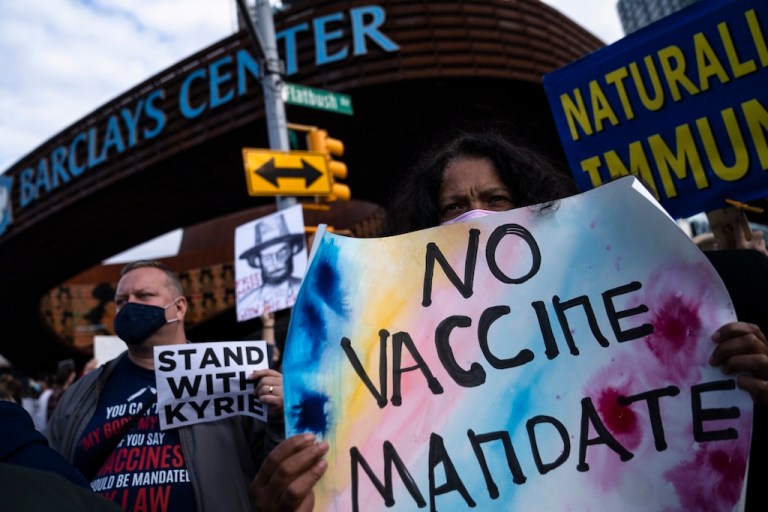 FILE - Protesters rallying against COVID-19 vaccination mandates gather in the street outside the Barclays Center before an NBA basketball game between the Brooklyn Nets and the Charlotte Hornets, Sunday, Oct. 24, 2021, in New York. (AP Photo/John Minchillo, File)