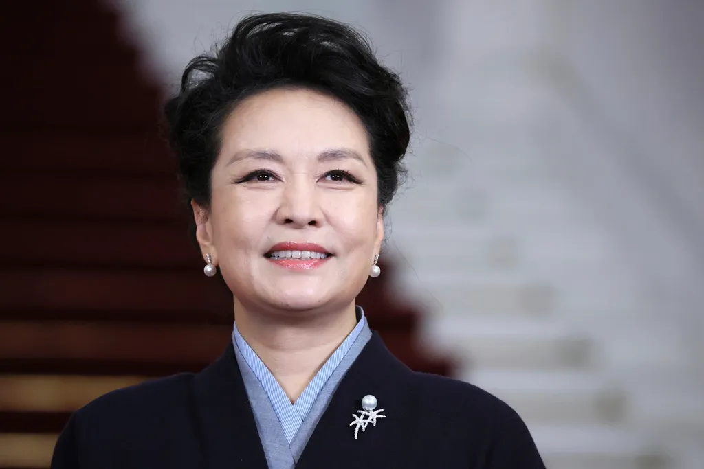 Chinese President Xi Jinping's wife Peng Liyuan smiles as she poses for a photo with Chinese President Xi Jinping and Russian President Vladimir Putin during during an opening ceremony of the Belt and Road Forum in Beijing, China, on Tuesday, Oct. 17, 2023. (Sergey Savostyanov, Sputnik, Kremlin Pool Photo via AP)