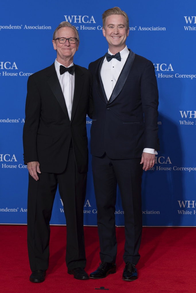 Journalists Steve Doocy, left, and Peter Doocy pose for photographers as they arrive at the annual White House Correspondents' Association Dinner in Washington, Saturday, April 27, 2024. (AP Photo/Jose Luis Magana)
