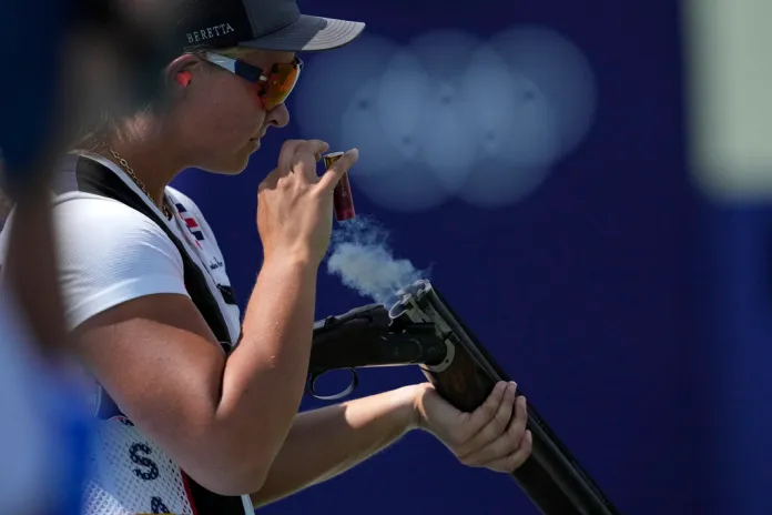 Austen Jewell Smith of the United States ejects empty cartridges from her gun