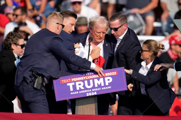 Republican presidential candidate former President Donald Trump is helped off the stage at a campaign event in Butler, Pa.
