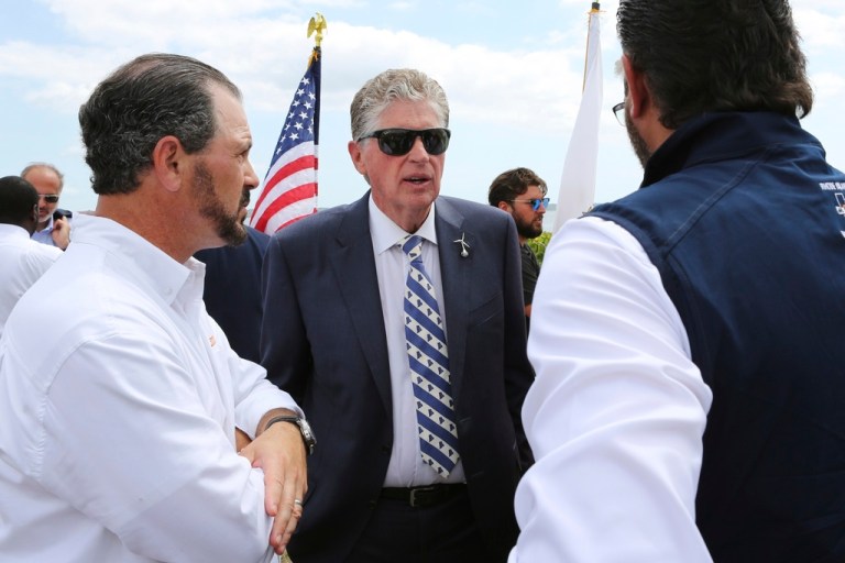 Rhode Island Gov. Dan McKee, center, speaks with Laborers' International Union of North America leaders Donato Bianco, left, and Michael Sabitoni, right, after a news conference in North Kingstown, R.I., on Aug. 25, 2025.