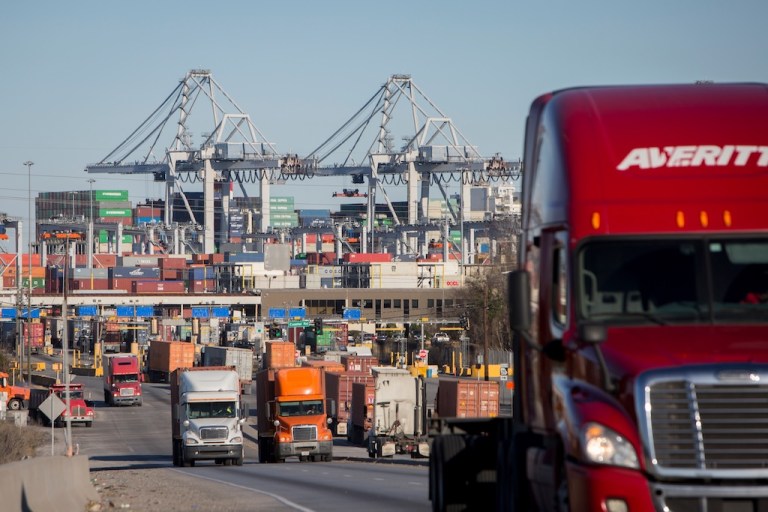 Tractor-trailers drive cargo out of the Port of Savannah in Savannah, Ga.