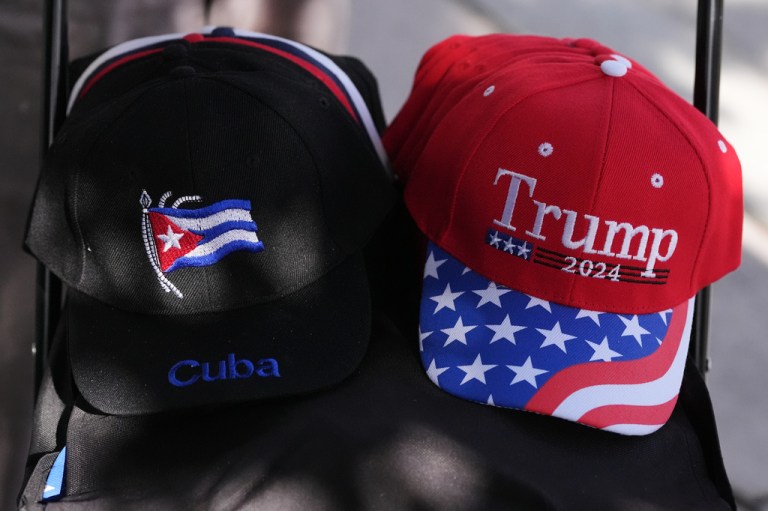 A vendor sells caps supporting Cuba and Trump.