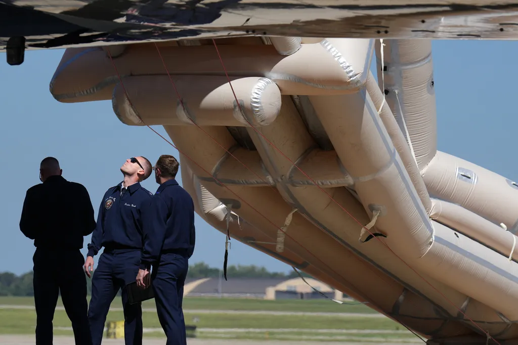 U.S, Air Force personnel work after an emergency inflatable slide deployed before President Donald Trump arrived to board at Joint Base Andrews, Md., Wednesday, Sept. 9, 2026. (AP Photo/Jacquelyn Martin)